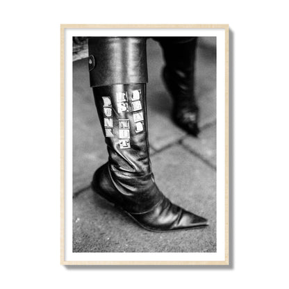 Fine art black and white photo of a woman's black leather boot with the words Punk is Not Dead, archival pigment print, collector size, natural wood frame.