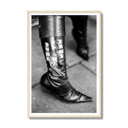 Fine art black and white photo of a woman's black leather boot with the words Punk is Not Dead, archival pigment print, gallery size, natural wood frame.