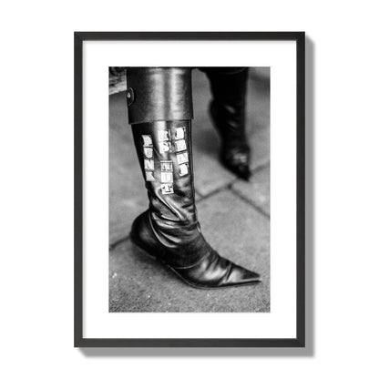 Fine art black and white photo of a woman's black leather boot with the words Punk is Not Dead, archival pigment print, large size, black frame.