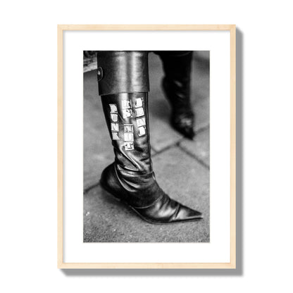 Fine art black and white photo of a woman's black leather boot with the words Punk is Not Dead, archival pigment print, large size, natural wood frame.