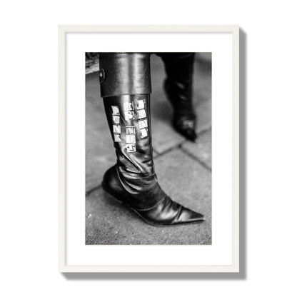 Fine art black and white photo of a woman's black leather boot with the words Punk is Not Dead, archival pigment print, large size, white frame.