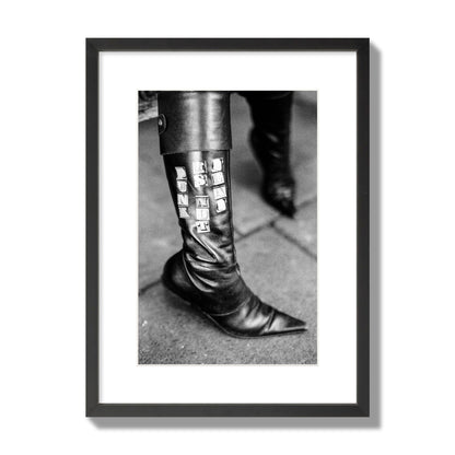 Fine art black and white photo of a woman's black leather boot with the words Punk is Not Dead, archival pigment print, medium size, black frame.