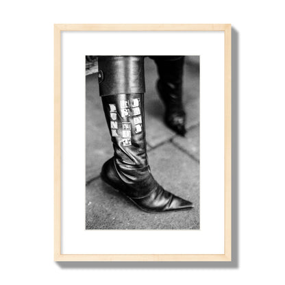 Fine art black and white photo of a woman's black leather boot with the words Punk is Not Dead, archival pigment print, medium size, natural wood frame.