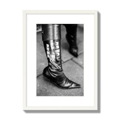 Fine art black and white photo of a woman's black leather boot with the words Punk is Not Dead, archival pigment print, medium size, white frame.