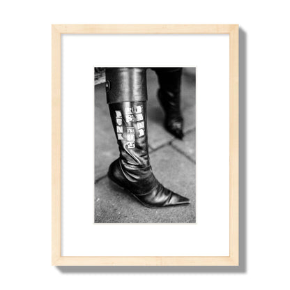 Fine art black and white photo of a woman's black leather boot with the words Punk is Not Dead, archival pigment print, small size, natural wood frame.