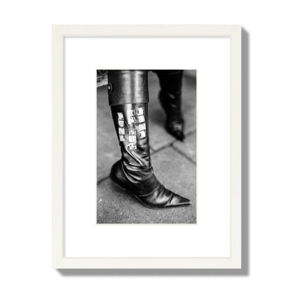 Fine art black and white photo of a woman's black leather boot with the words Punk is Not Dead, archival pigment print, small size, white frame.