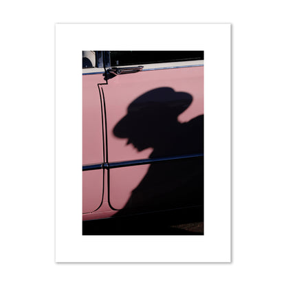 Fine art photograph of a man's shadow cast on a pink retro car, archival pigment print, medium size, print.