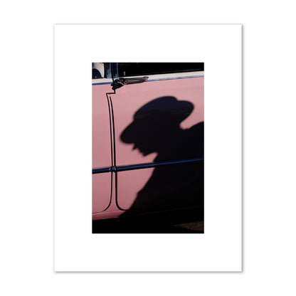 Fine art photograph of a man's shadow cast on a pink retro car, archival pigment print, small size, print.