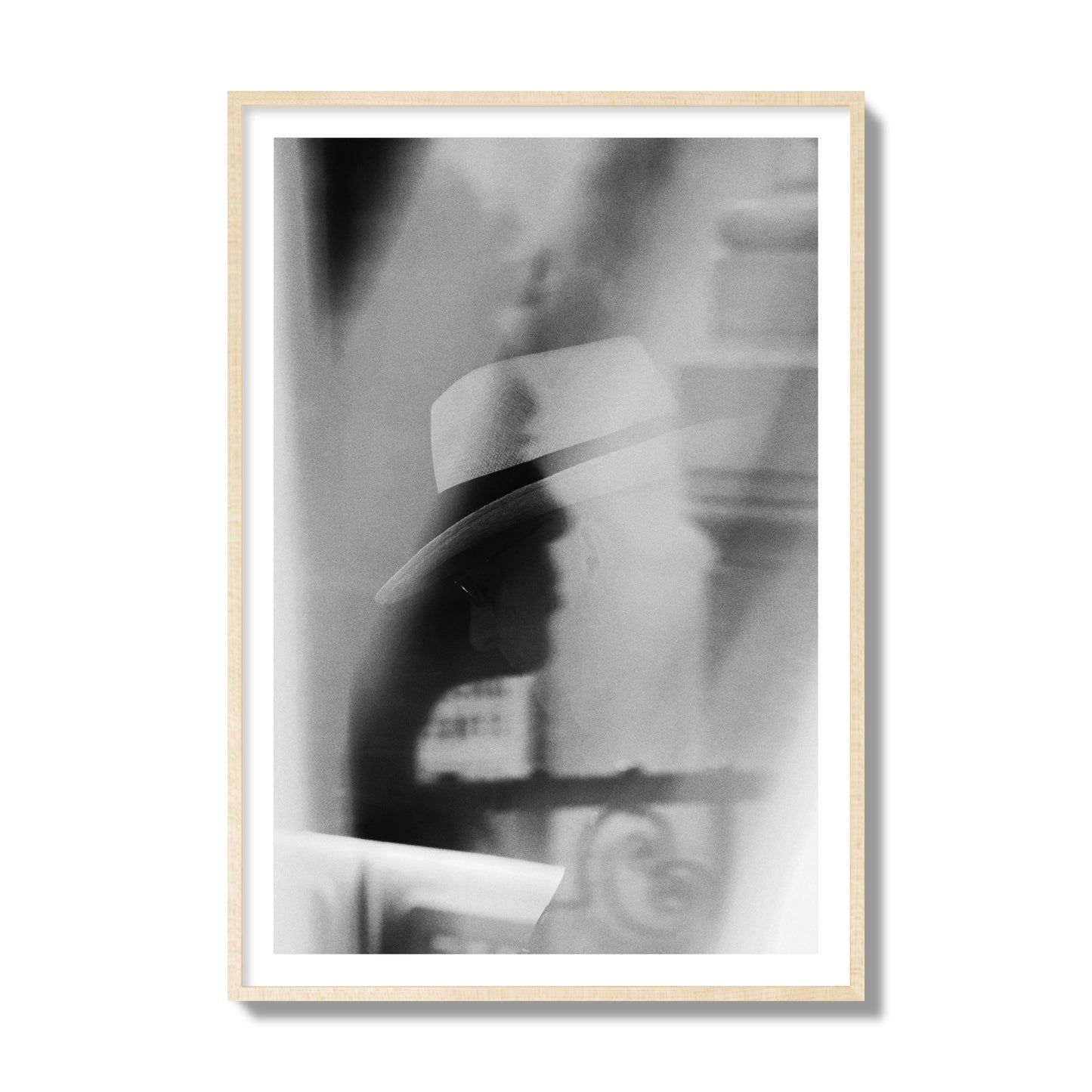 Fine art black and white photograph of multiple faces reflecting in a window, archival pigment print, collector size, natural wood frame.
