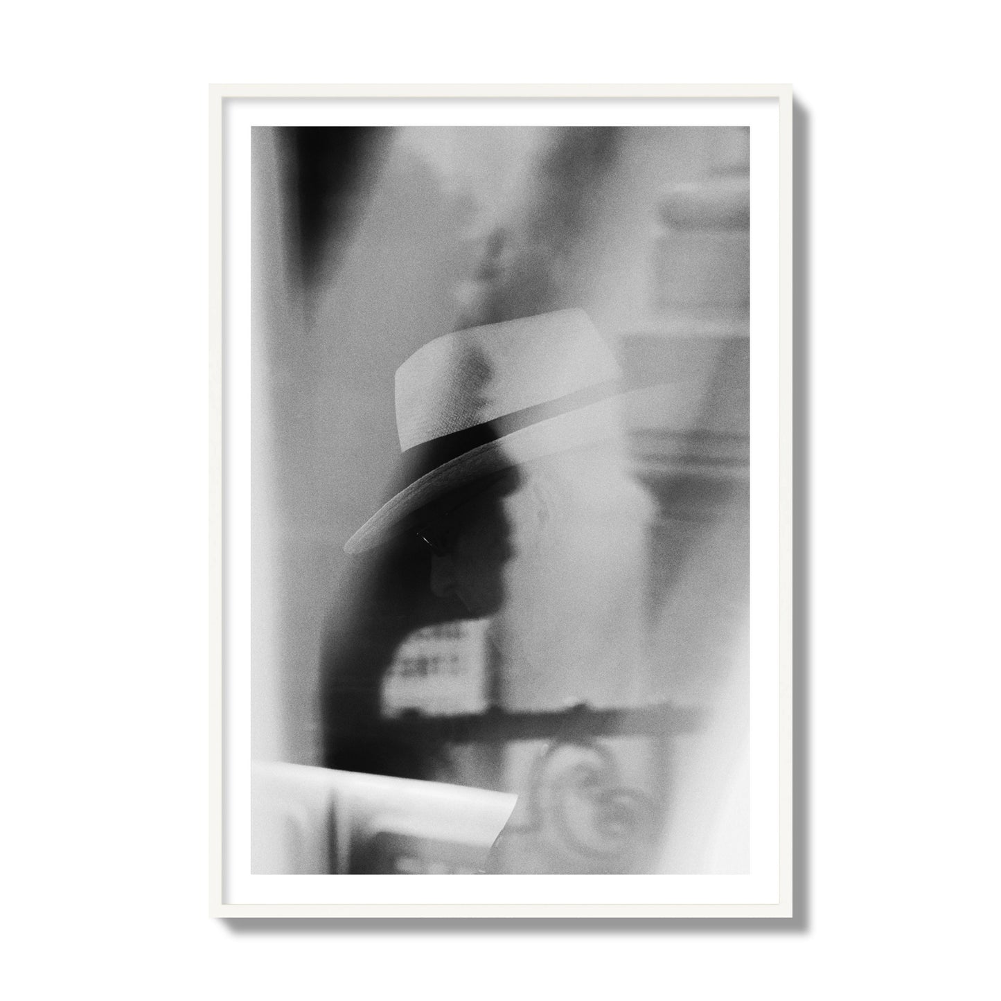 Fine art black and white photograph of multiple faces reflecting in a window, archival pigment print, collector size, white frame.