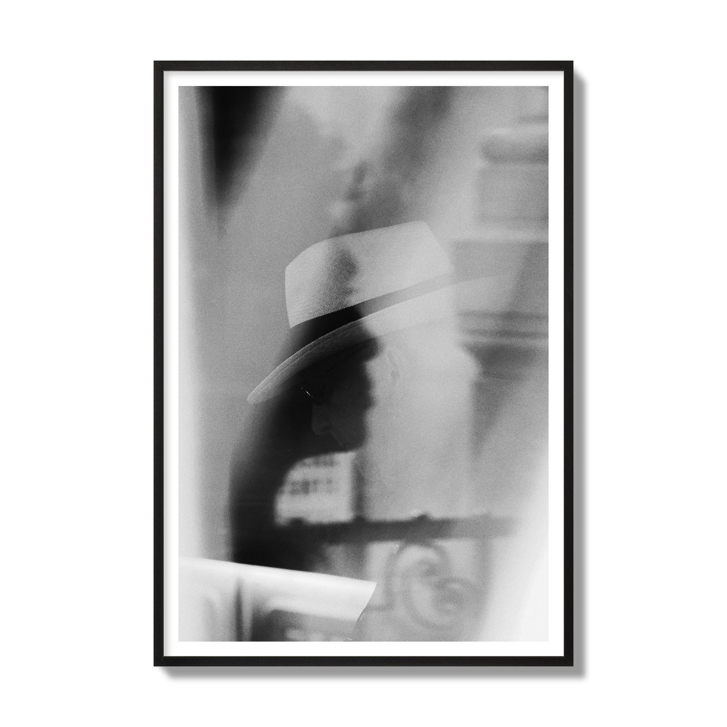 Fine art black and white photograph of multiple faces reflecting in a window, archival pigment print, gallery size, black frame.