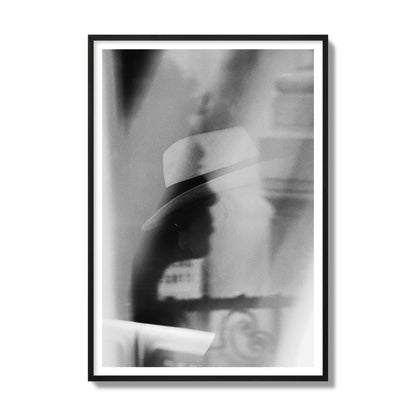 Fine art black and white photograph of multiple faces reflecting in a window, archival pigment print, gallery size, black frame.
