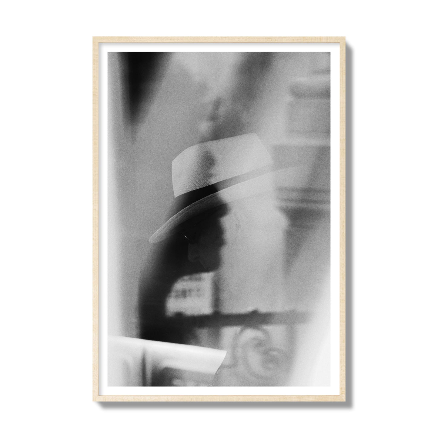 Fine art black and white photograph of multiple faces reflecting in a window, archival pigment print, gallery size, natural wood frame.