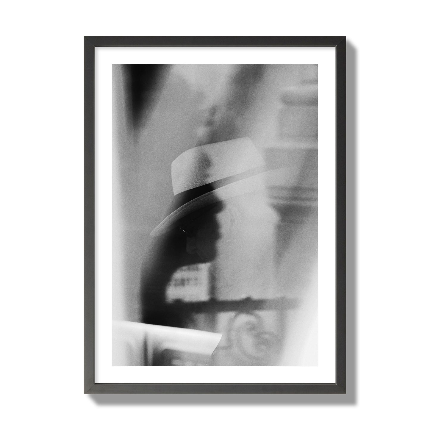 Fine art black and white photograph of multiple faces reflecting in a window, archival pigment print, giant size, black frame.