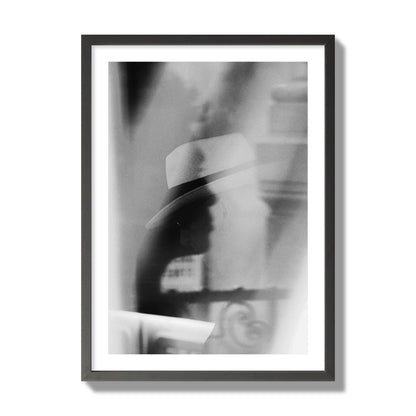 Fine art black and white photograph of multiple faces reflecting in a window, archival pigment print, giant size, black frame.