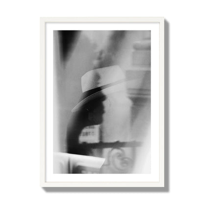 Fine art black and white photograph of multiple faces reflecting in a window, archival pigment print, giant size, white frame.