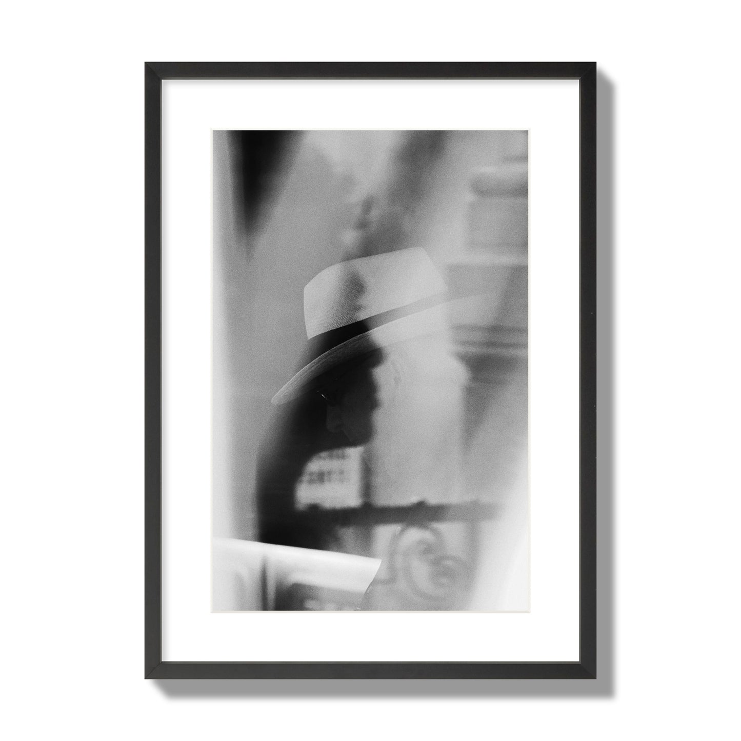 Fine art black and white photograph of multiple faces reflecting in a window, archival pigment print, large size, black frame.
