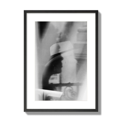 Fine art black and white photograph of multiple faces reflecting in a window, archival pigment print, large size, black frame.