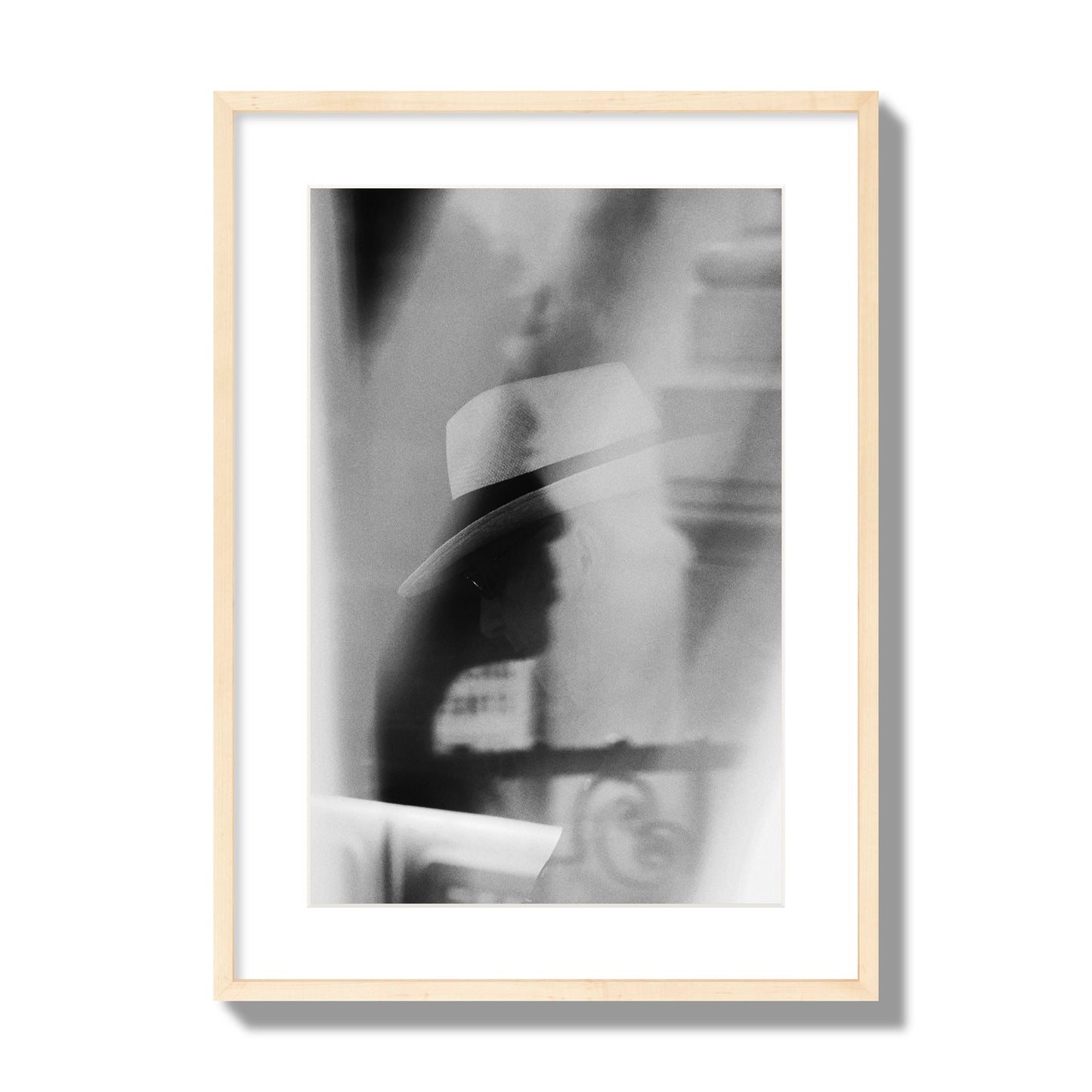 Fine art black and white photograph of multiple faces reflecting in a window, archival pigment print, large size, natural wood frame.