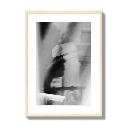 Fine art black and white photograph of multiple faces reflecting in a window, archival pigment print, large size, natural wood frame.