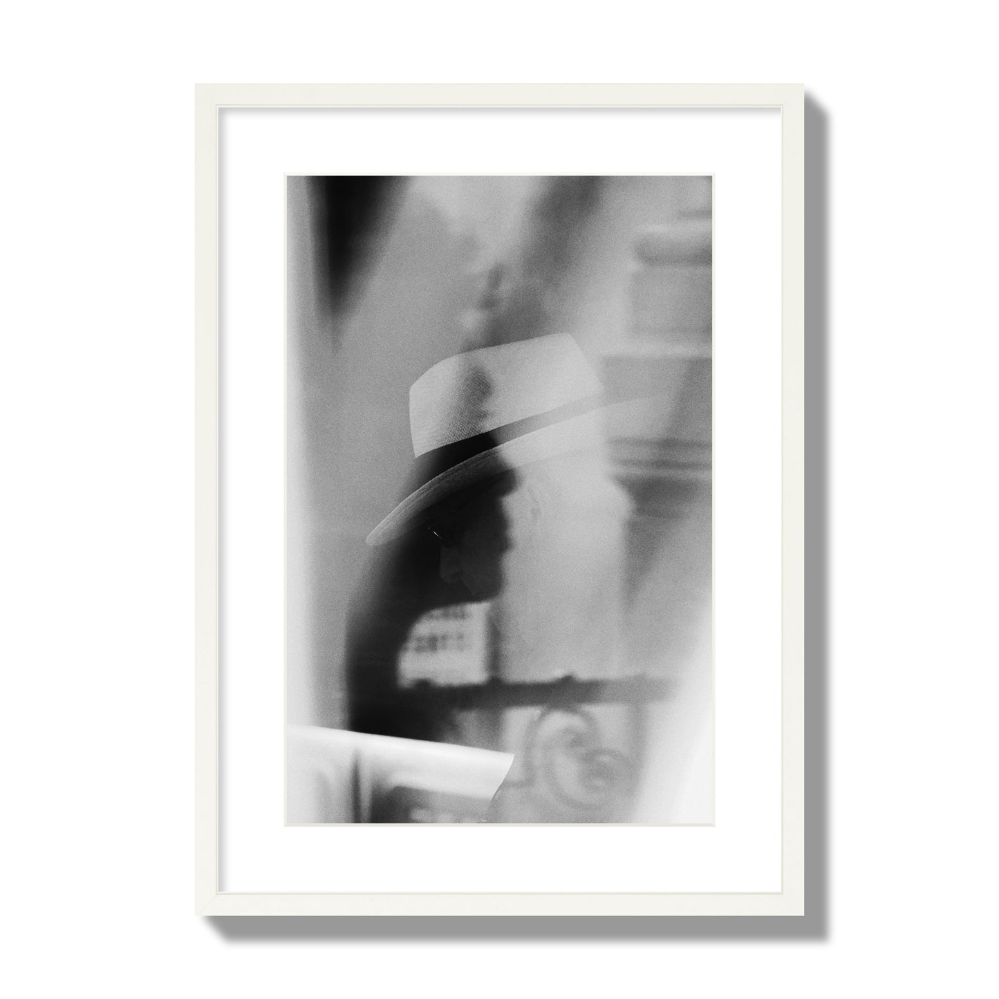Fine art black and white photograph of multiple faces reflecting in a window, archival pigment print, large size, white frame.
