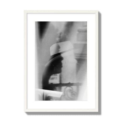 Fine art black and white photograph of multiple faces reflecting in a window, archival pigment print, large size, white frame.