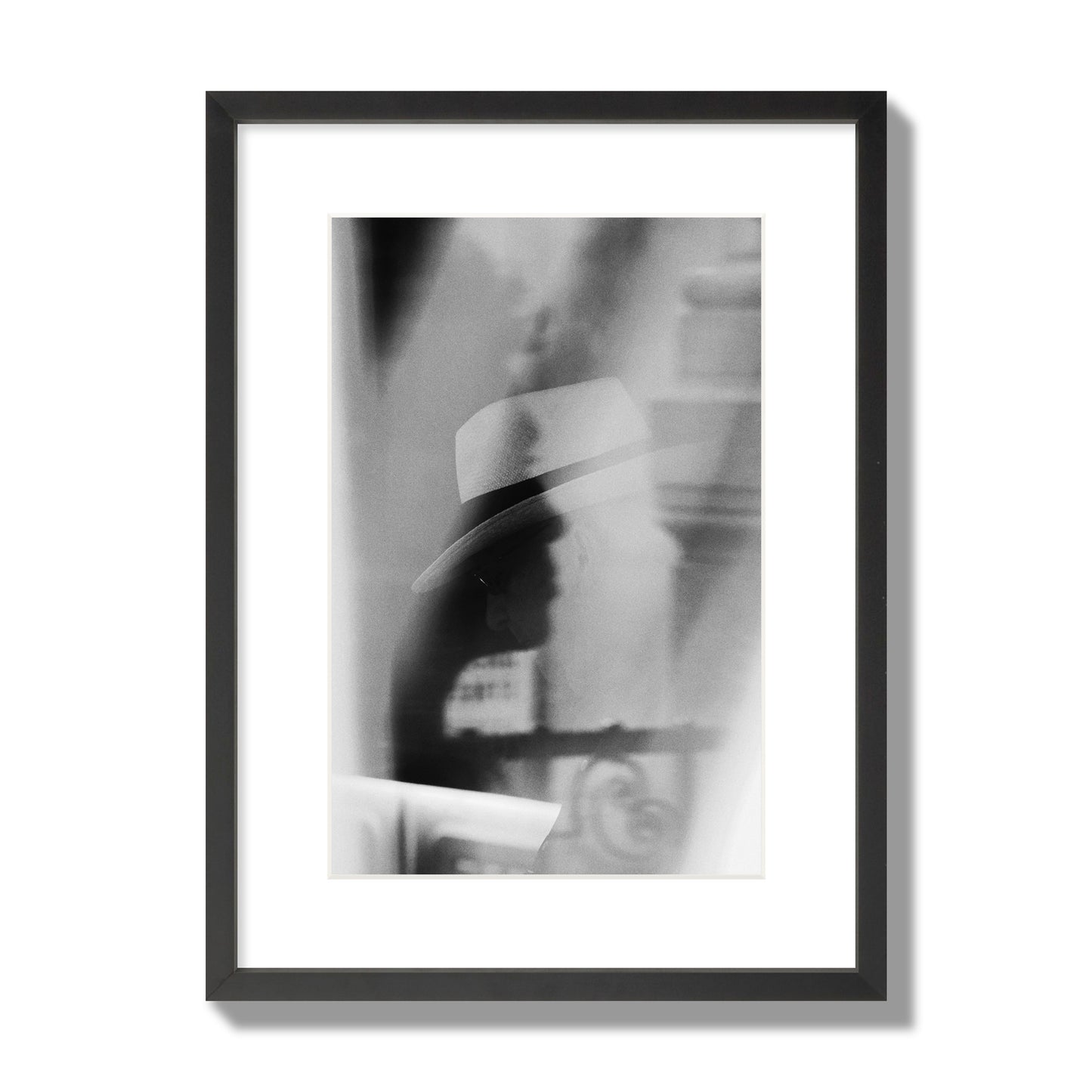 Fine art black and white photograph of multiple faces reflecting in a window, archival pigment print, medium size, black frame.
