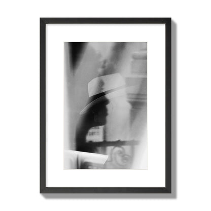 Fine art black and white photograph of multiple faces reflecting in a window, archival pigment print, medium size, black frame.