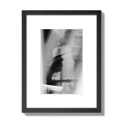 Fine art black and white photograph of multiple faces reflecting in a window, archival pigment print, small size, black frame.