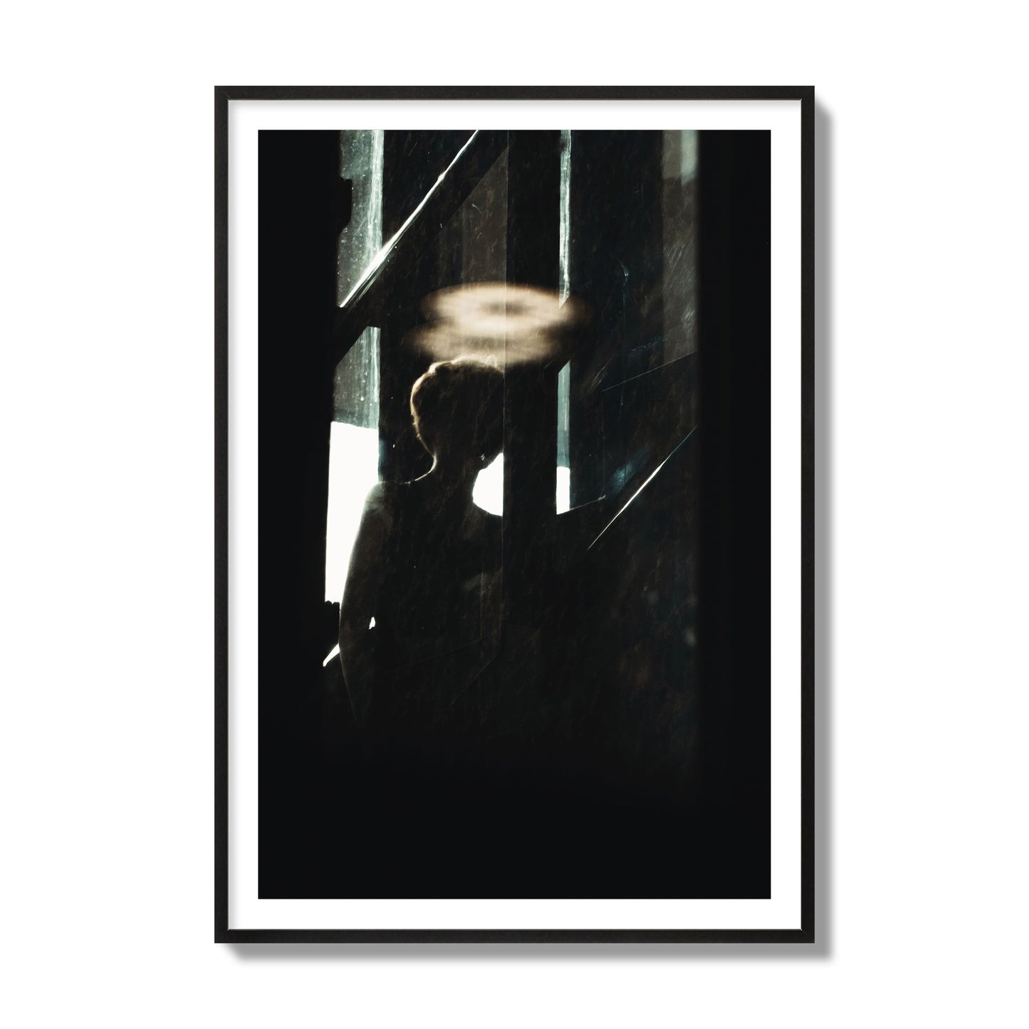 Fine art photograph of a silhouetted woman with a glowing halo light above her head, archival pigment print, collector size, black frame.