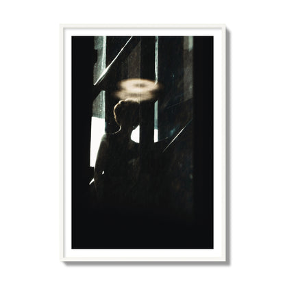 Fine art photograph of a silhouetted woman with a glowing halo light above her head, archival pigment print, collector size, white frame.