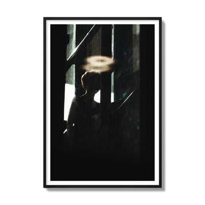 Fine art photograph of a silhouetted woman with a glowing halo light above her head, archival pigment print, gallery size, black frame.