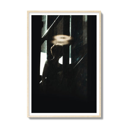 Fine art photograph of a silhouetted woman with a glowing halo light above her head, archival pigment print, gallery size, natural wood frame.