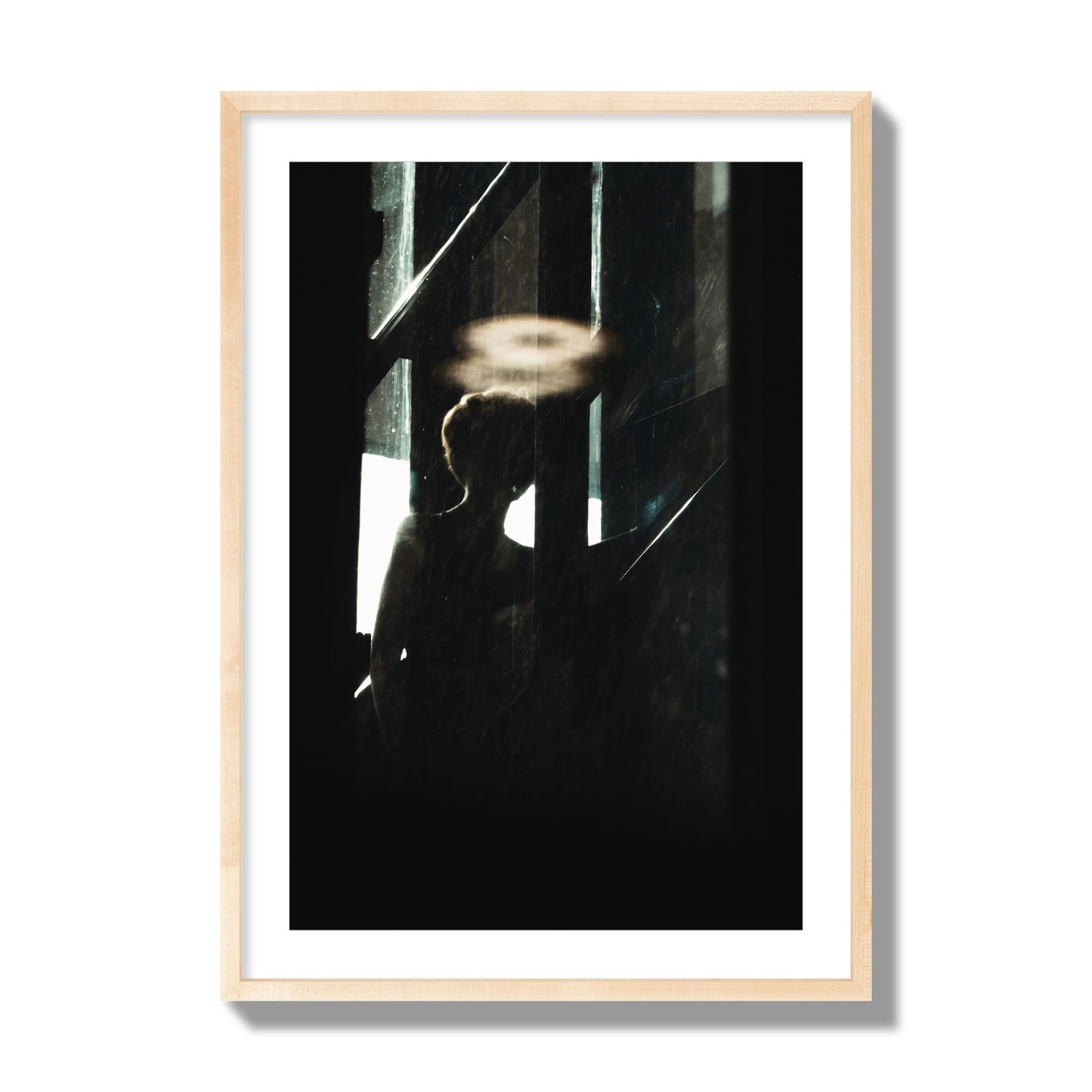 Fine art photograph of a silhouetted woman with a glowing halo light above her head, archival pigment print, giant size, natural wood frame.