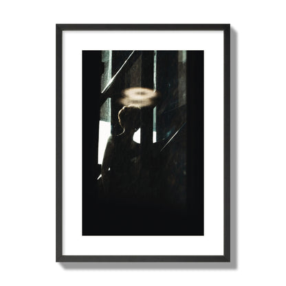 Fine art photograph of a silhouetted woman with a glowing halo light above her head, archival pigment print, large size, black frame.