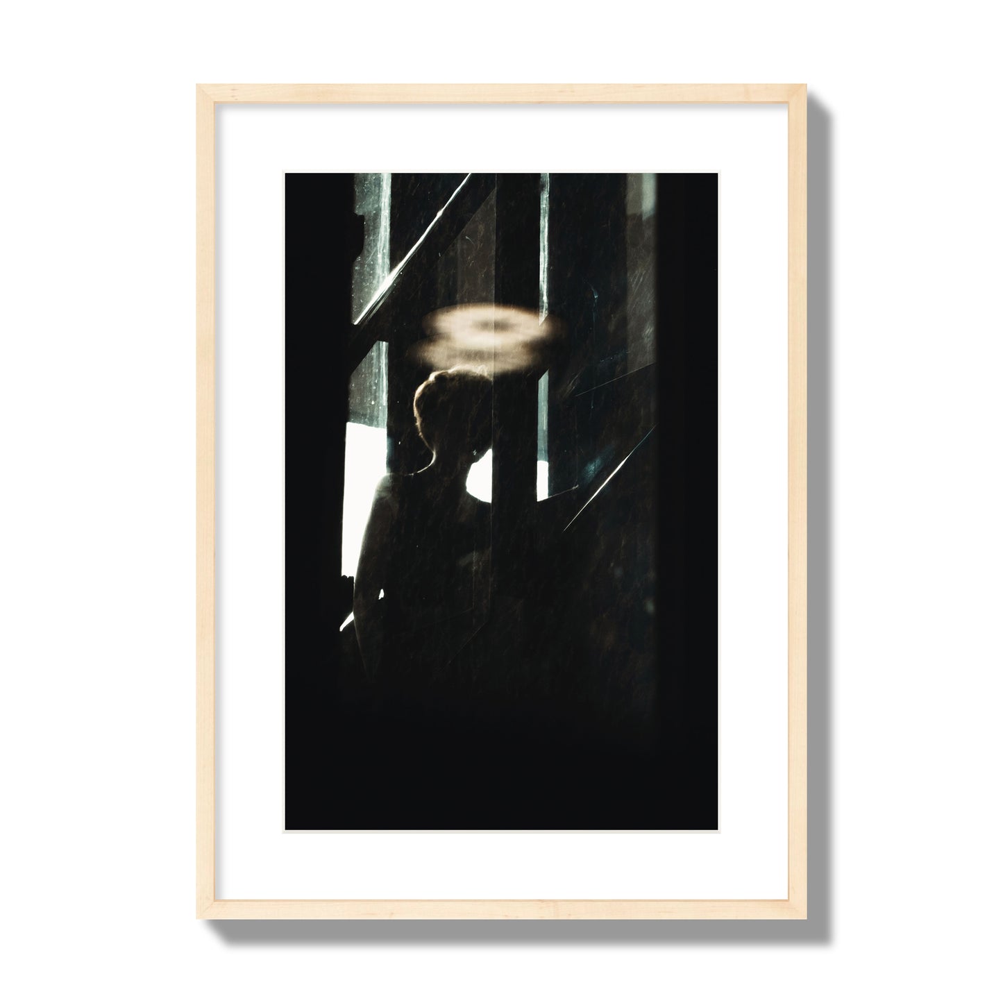 Fine art photograph of a silhouetted woman with a glowing halo light above her head, archival pigment print, large size, natural wood frame.