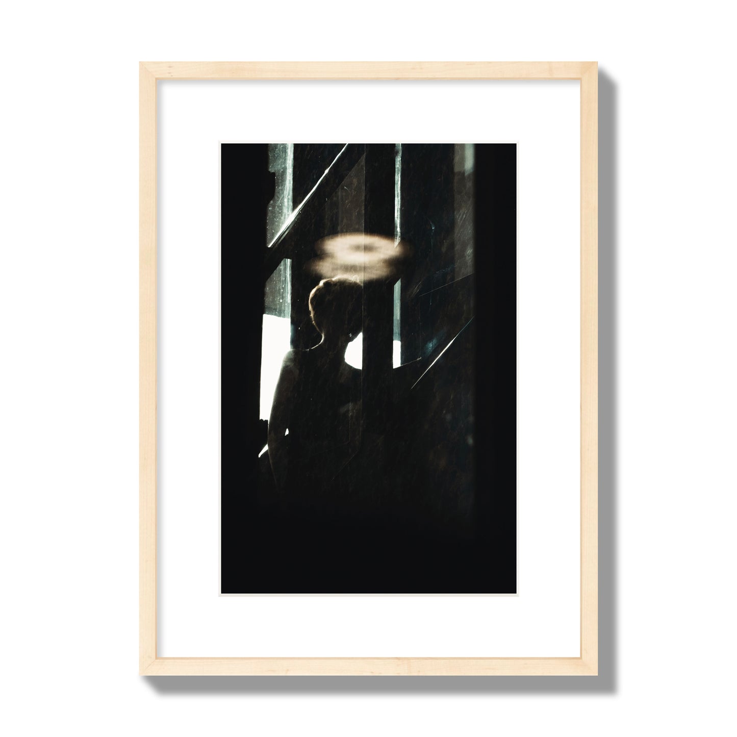 Fine art photograph of a silhouetted woman with a glowing halo light above her head, archival pigment print, medium size, natural wood frame.