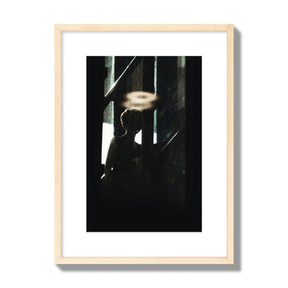 Fine art photograph of a silhouetted woman with a glowing halo light above her head, archival pigment print, medium size, natural wood frame.