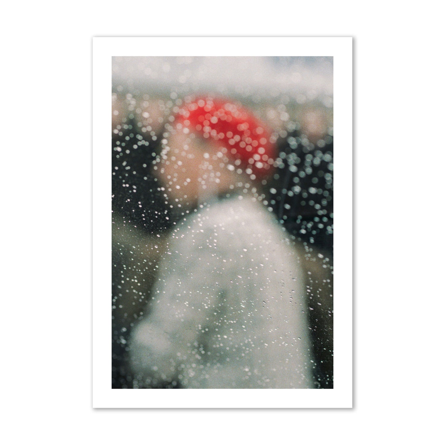 Fine art photograph of a woman with a red hat through raindrops on a window, archival pigment print, collector size, print.
