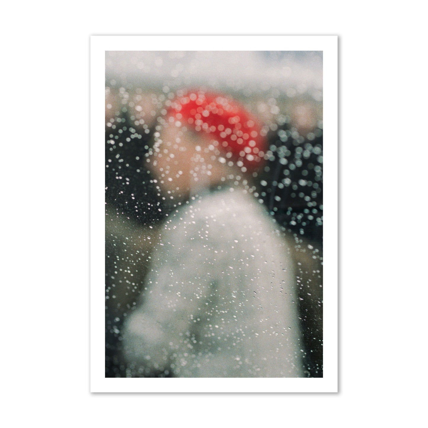 Fine art photograph of a woman with a red hat through raindrops on a window, archival pigment print, gallery size, print.