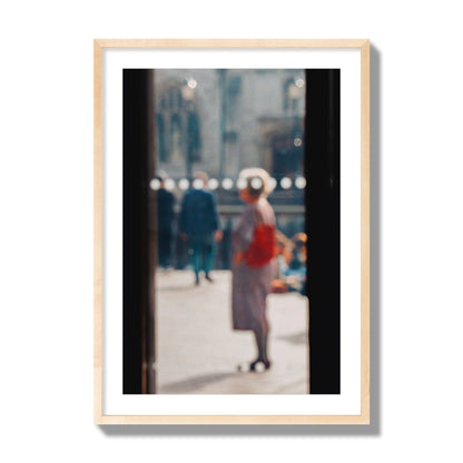 Fine art photograph of a blurred street scene with people and a storefront, archival pigment print, giant size, natural wood frame.