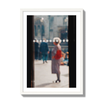 Fine art photograph of a blurred street scene with people and a storefront, archival pigment print, giant size, white frame.