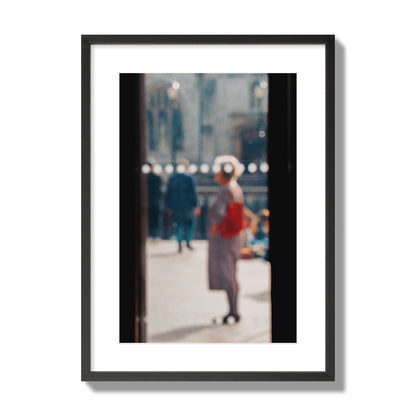 Fine art photograph of a blurred street scene with people and a storefront, archival pigment print, large size, black frame.