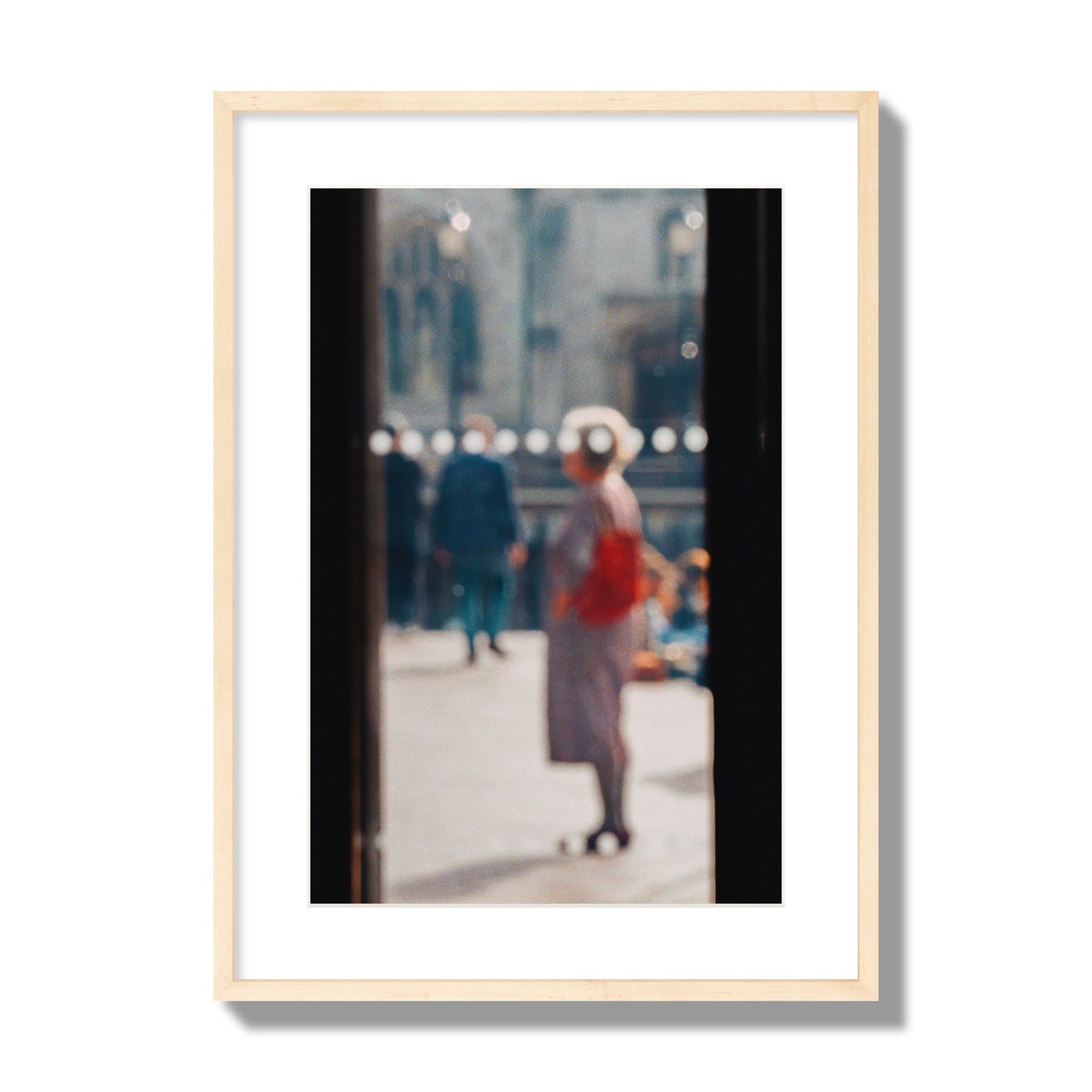 Fine art photograph of a blurred street scene with people and a storefront, archival pigment print, large size, natural wood frame.