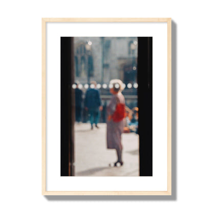 Fine art photograph of a blurred street scene with people and a storefront, archival pigment print, large size, natural wood frame.