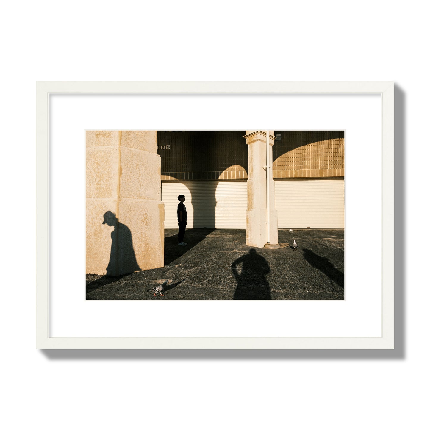 Fine art street photograph of shadows cast on the walls of the Indiana Tea House at Cottesloe Perth Western Australia. Archival pigment print, medium size, white frame.