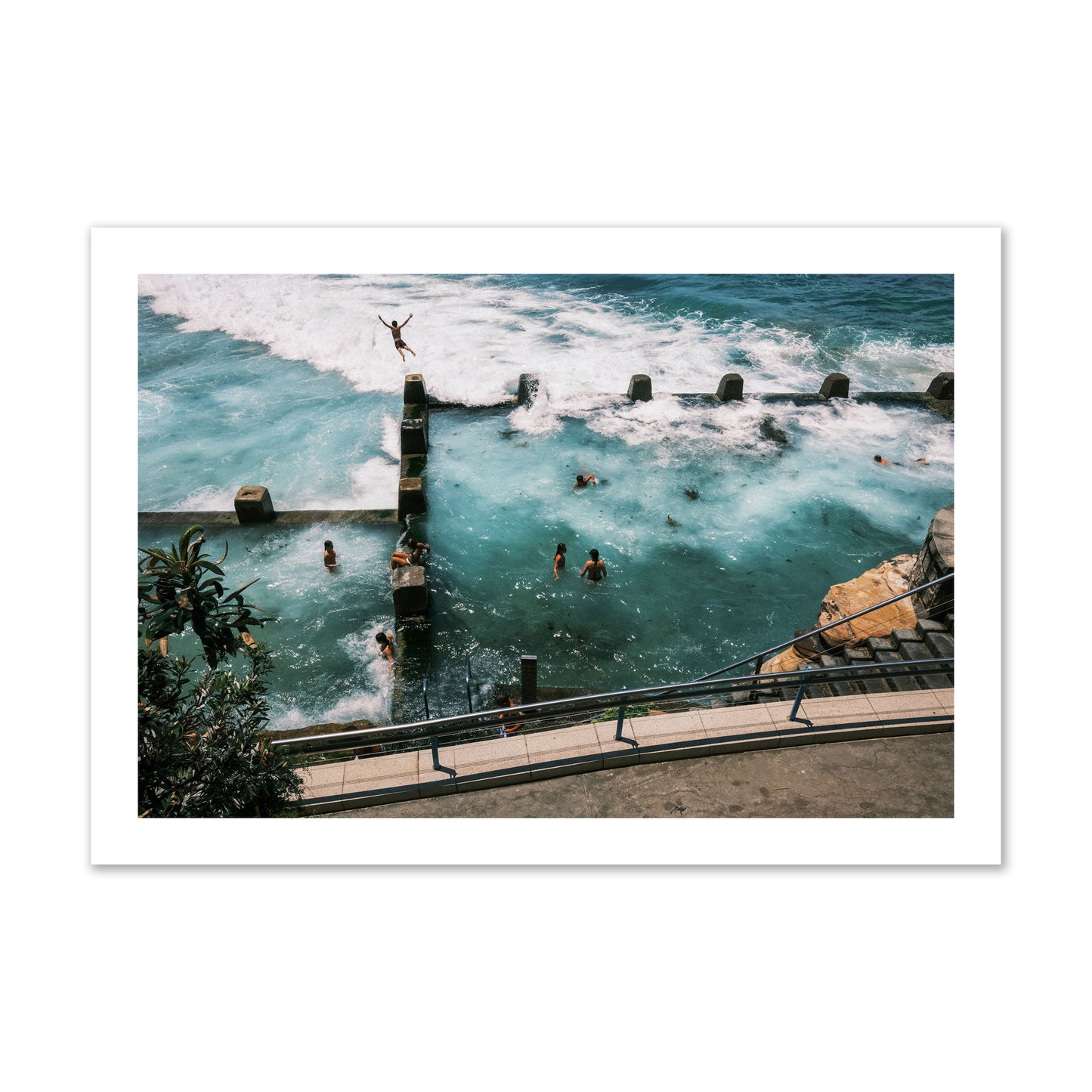 Fine art street photograph of a man jumping into the ocean. Archival pigment print, collector size, print.
