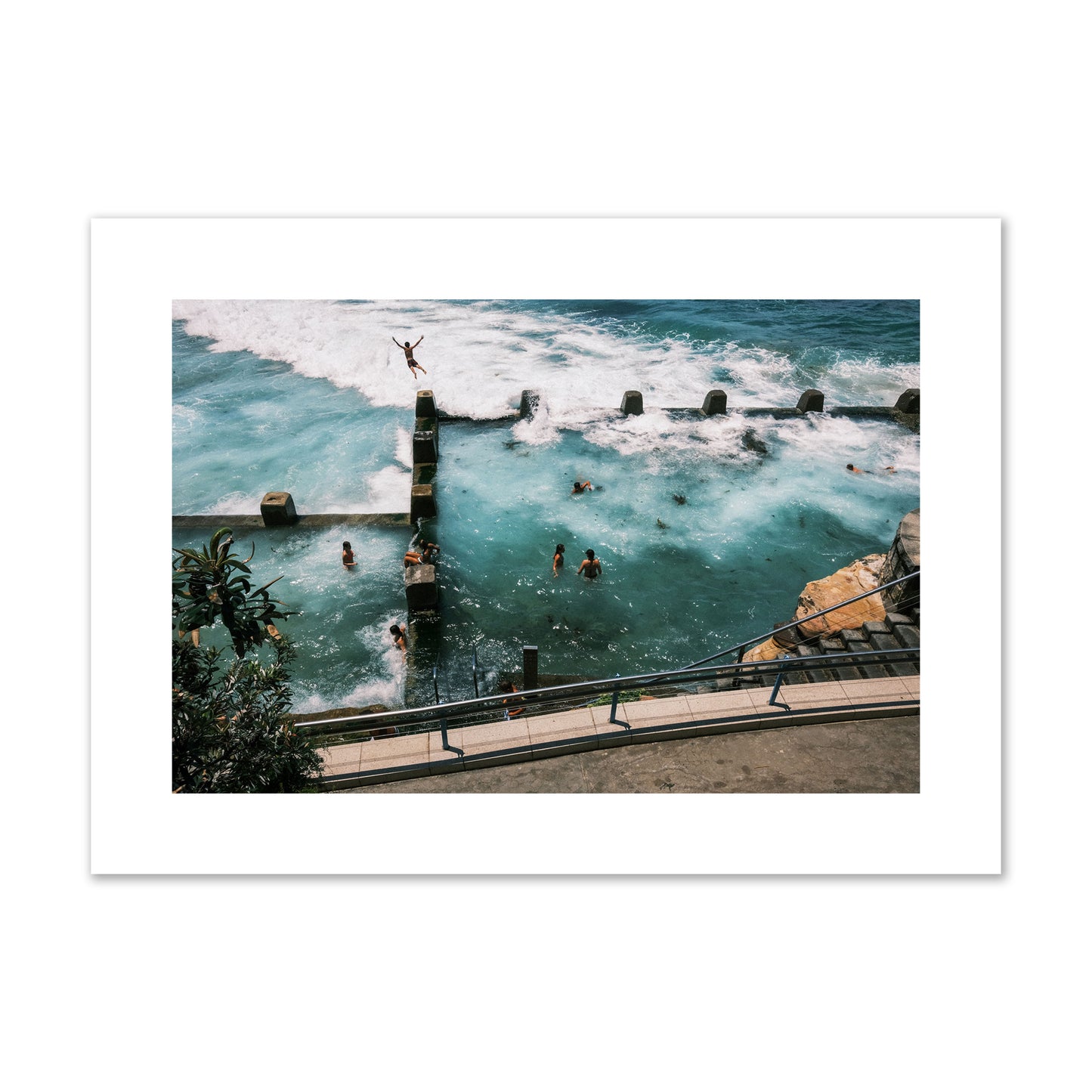 Fine art street photograph of a man jumping into the ocean. Archival pigment print, large size, print.