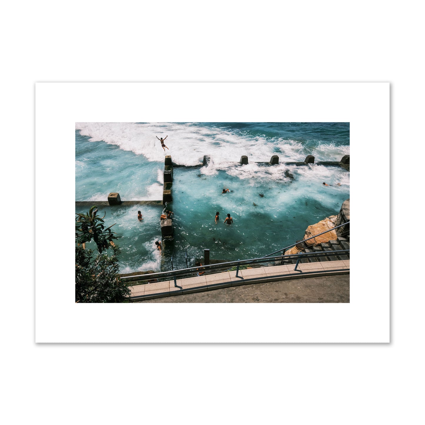 Fine art street photograph of a man jumping into the ocean. Archival pigment print, medium size, print.