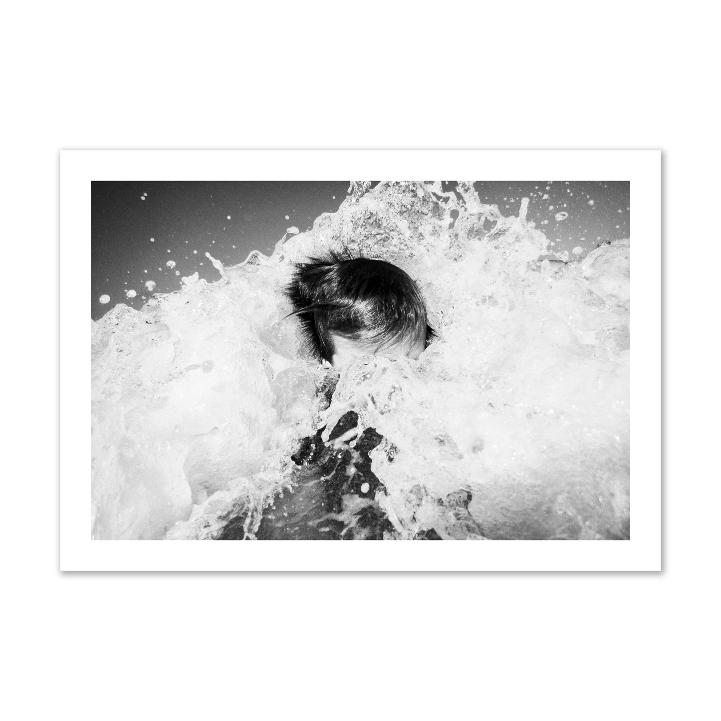 Fine art street photograph of an ocean wave crashing over a swimmer. Archival pigment print, collector size, print.